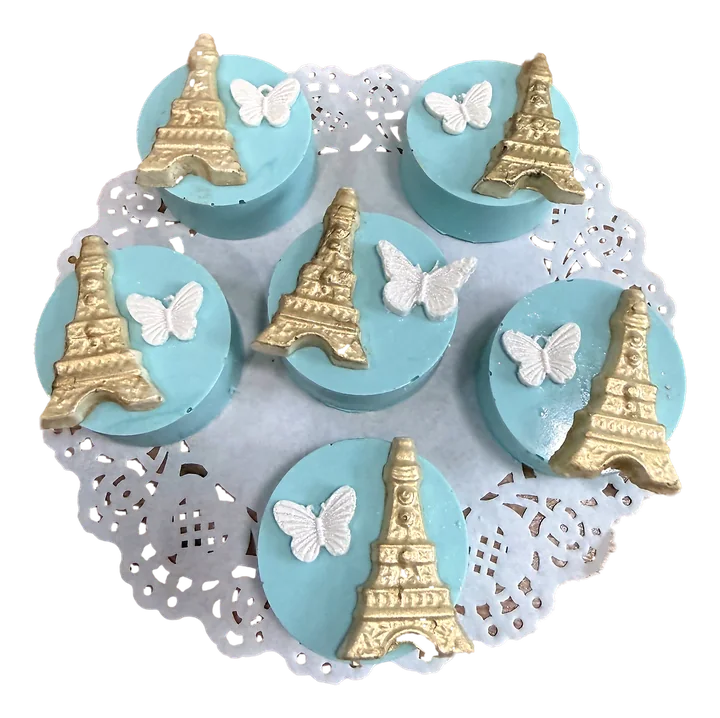 Robin's-egg blue treats topped with gold Eiffel Towers and white butterflies